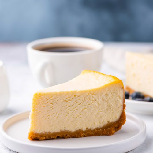 Classical New York Style Cheesecake And Coffee On Table. Side View. Coffee and Cake